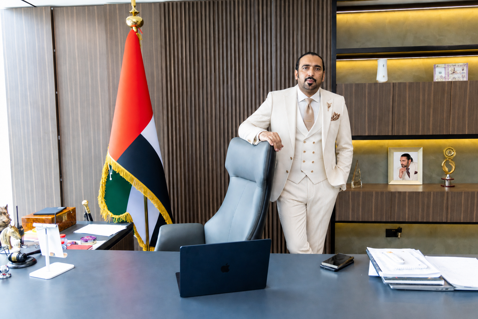 Syed Mudassar Khushnood in his Dubai office with the UAE flag